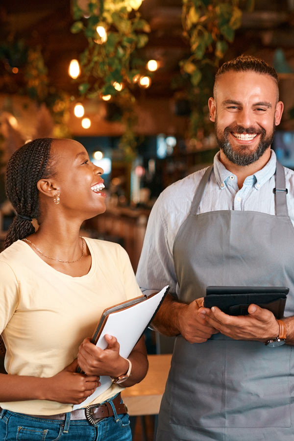 male and female restaurant owners smiling, small business funding